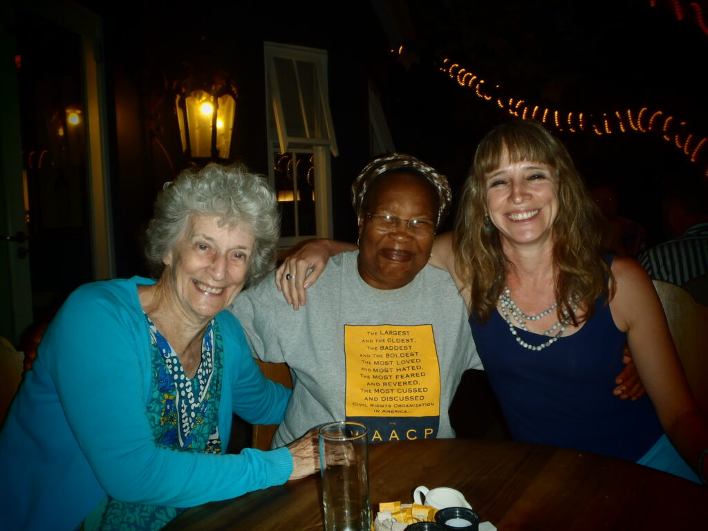 All smiles - my mom in blue on the left, her friend in the middle wearing a legendary T-shirt which reads: The largest and the oldest, the baddest and the boldest, the most loved and the most hated, the most feared and revered, the most cussed and discussed Civil Rights Organization in America, and me also in blue on the right. The three of us in my Mom's favourite restaurant.